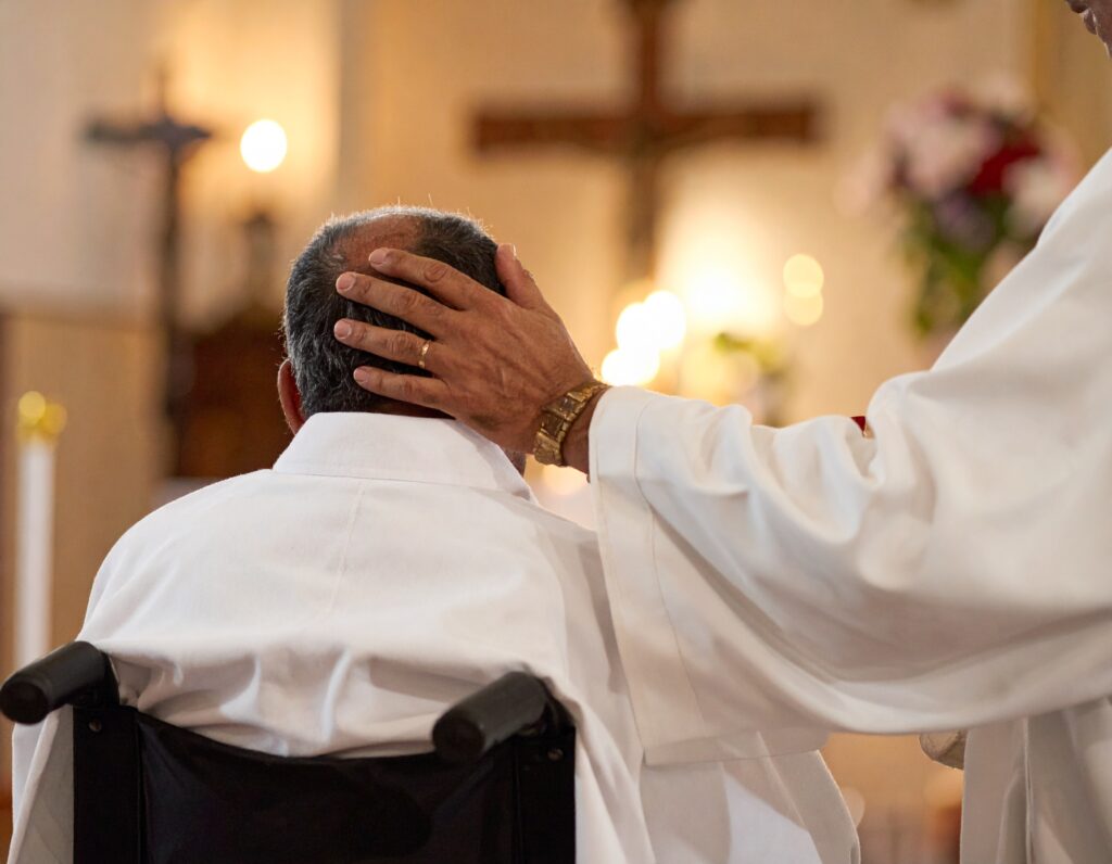 Firefly A Catholic priest in a white stole and alb administering the Anointing of the Sick to a pers 1024x796